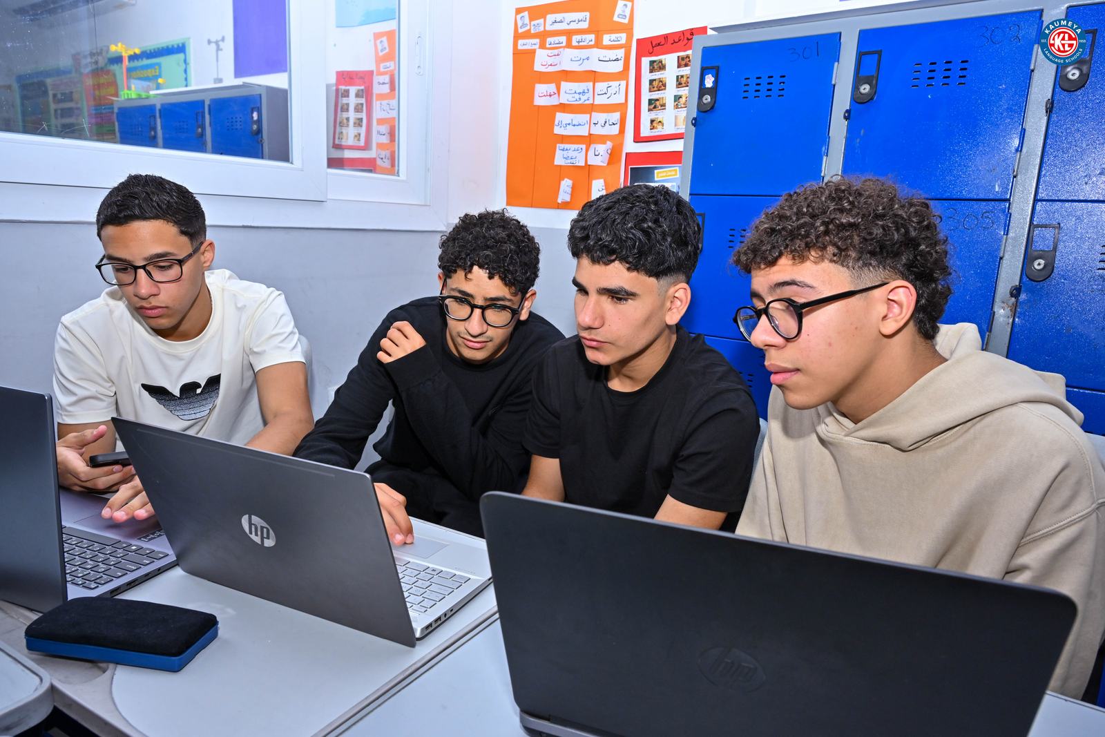 Students building their solution on laptops