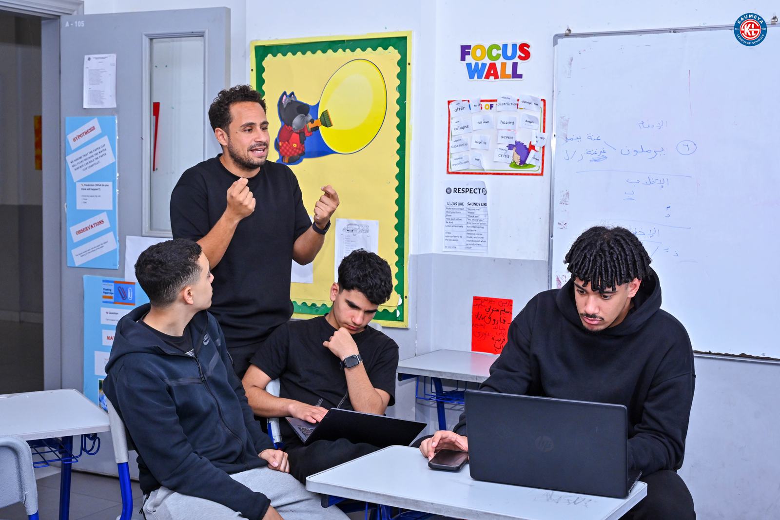 A coach explaining a concept to three students